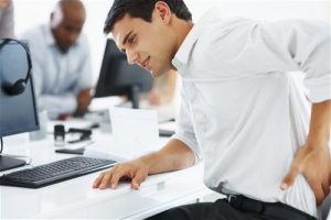Man at office with low back pain