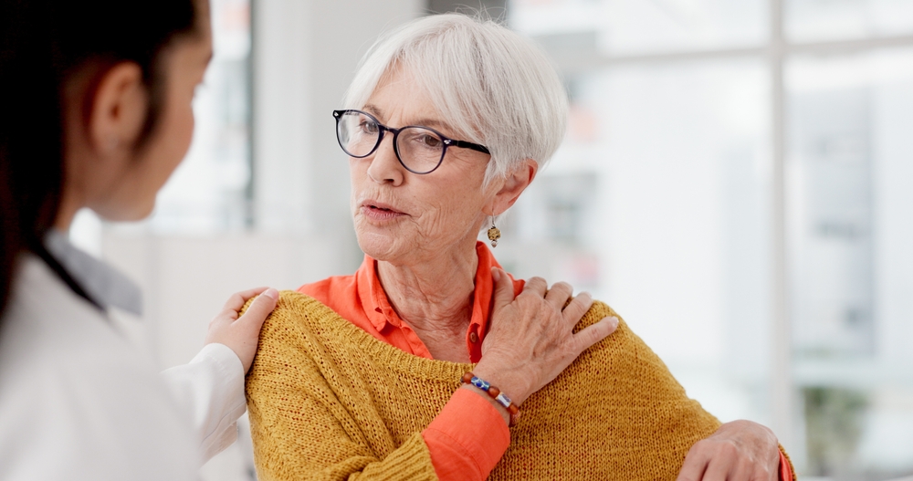 elderly woman talking to doctor about shoulder pain